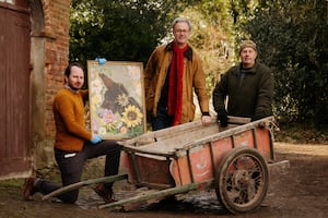 Dr Robert MacKinnon from the Soldiers of Shropshire Museum; James Nason, owner of Pitchford Hall and Derek Owen, gardener at the hall, with a painting of Jessie the donkey and her old cart