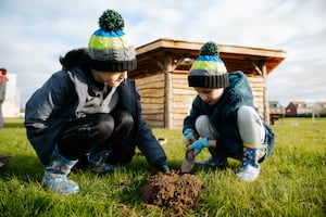 Pupils helping at the tree planting event.