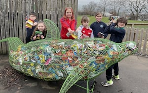 Ysgol Trefonnnen pupils in Llandrindod Wells filling up the crisp packet dolphin.