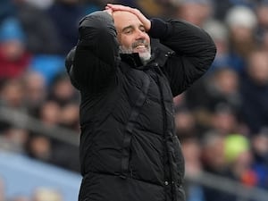 Manchester City manager Pep Guardiola puts his hands on his head while stood on the touchline