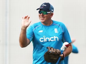 Chris Silverwood, wearing a cap and sunglasses, raises his right arm during a nets session