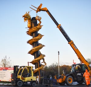 The sculpture being moved into place.