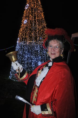 Town Crier Jan Swindale with a new golden Christmas tree, part of Llandrindod Wells lights display. Image: Andy Compton