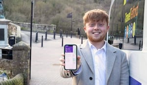 Councillor Ollie Vickers, (Lab) Cabinet Member for the Economy holding a mobile phone showing the app. Picture; Telford & Wrekin Council