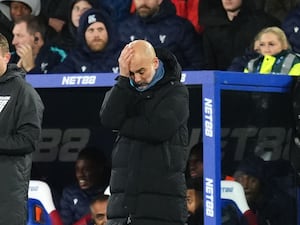 Manchester City manager Pep Guardiola holds his head in his hand