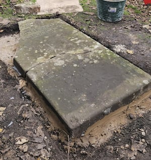 The stone being put back in place.