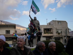 People attend a rally celebrating the fall of Syrian President Bashar Assad’s government (Matias Delacroix/AP)