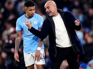 Pep Guardiola passes on instructions to Savinho on the touchline