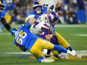 Los Angeles Rams defensive tackle Braden Fiske (55) and Michael Hoecht (97) sack Minnesota Vikings quarterback Sam Darnold