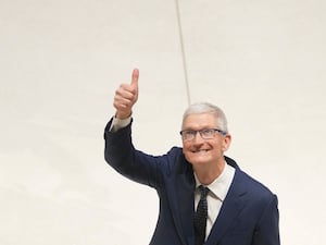 Apple CEO Tim Cook raises his thumb