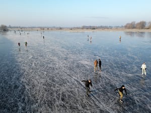 Skaters on a frozen flooded field in Upware, Cambridgeshire.