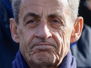 Former French President Nicolas Sarkozy looks on as he attends a ceremony at the Arc de Triomphe