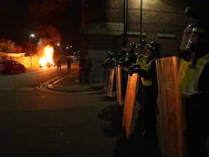 A police car burns as officers are deployed on the streets of Hartlepool following a violent protest