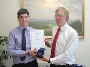 Nathan aged 17 years, is congratulated as Hereford College, accountancy student of the year by Doug Holmes, of Balfours.