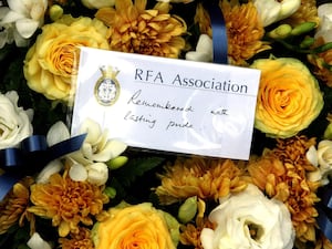 Flowers and a card at a Falklands Sir Galahad memorial service