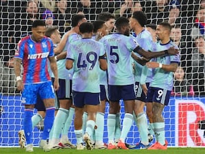 Arsenal players celebrate with a group hug