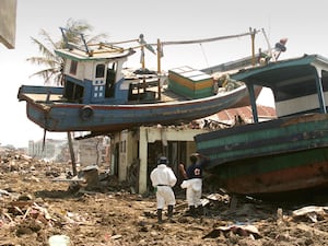 A boat on a roof in the aftermath of the Boxing Day tsunami in Indonesia