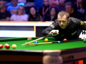 Mark Allen plays a shot with the rest