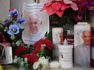 Candles and a photo of Pope Francis