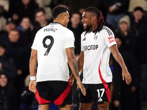 Alex Iwobi (right) celebrates after scoring against Brighton