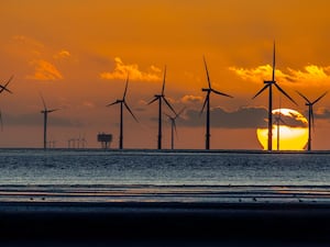 View of wind turbines at sunset