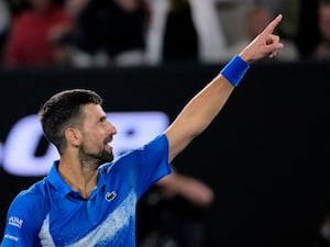 Novak Djokovic gestures to the crowd