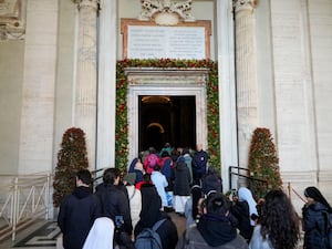 People walking through the Holy Door of St Peter’s Basilica at the Vatican