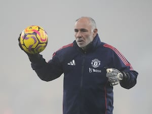 Manchester United goalkeeping coach Jorge Vital warms the players up