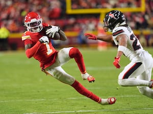 Kansas City Chiefs wide receiver Xavier Worthy catches a pass as Houston Texans cornerback Myles Bryant, right, defends