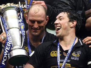 Lawrence Dallaglio holds a trophy while Tom Voyce laughs