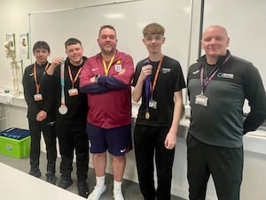 Kevin Fenner with sports students Ryan Povey, Liam Downing, Ethan Wynn and lecturer Jason Jones, who got to see and hold his gold and silver medals from the Euros and World Cup.