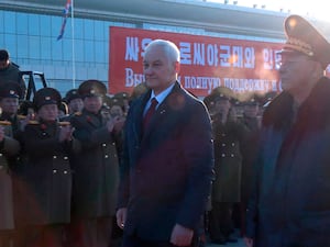 Andrei Belousov and No Kwang Chol walk past troops