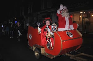 Town Crier Jan Swindale leading the Christmas parade with Santa. Image: Andy Compton