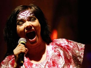 Bjork singing into a microphone