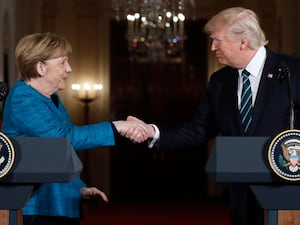 President Donald Trump and German Chancellor Angela Merkel shake hands