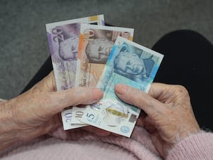 A pensioner holding bank notes