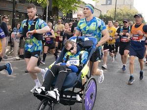 Kevin Sinfield pushes Rob Burrow in a wheelchair during the 2023 Leeds Marathon