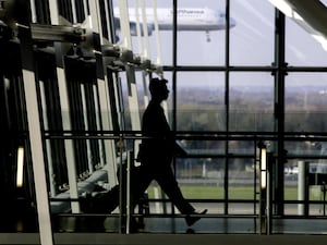 A passenger walks through Heathrow Airport