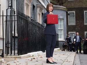 Chancellor Rachel Reeves holds up her ministerial red box