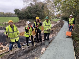 Volunteers celebrate the original scope completion - five months ahead of schedule. 