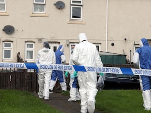 Forensic officers at the scene of the incident last year