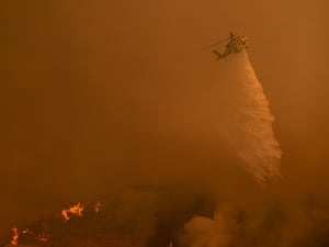 Water is dropped on the Palisades Fire by helicopter