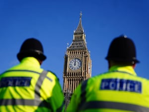 Two police officers walk past the Elizabeth Tower, better known as Big Ben, at the Houses of Parliament in Westminster, London