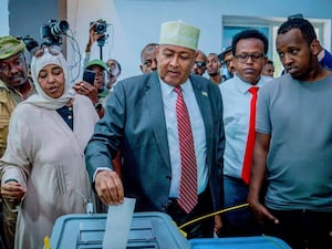 Abdirahman Mohamed Abdullahi, centre, casts his vote inside a polling station in Somaliland