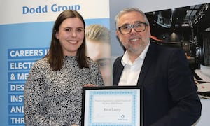 Kira receiving her award from Mark Davies, Regional Managing Director