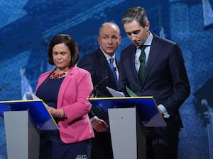 Mary Lou McDonald, Micheal Martin and Simon Harris stand near podiums