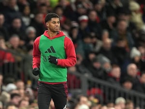 Marcus Rashford warms up on the touchline