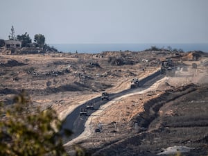 Israeli armoured vehicles move on in an area at the Israeli-Gaza border