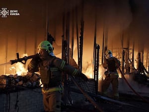 Rescuers put out a fire of a building which was resulted from Russian drone attack in Kyiv, Ukraine