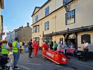 Kington's wheelbarrow race calling at Open Arms Kington at the Oxford